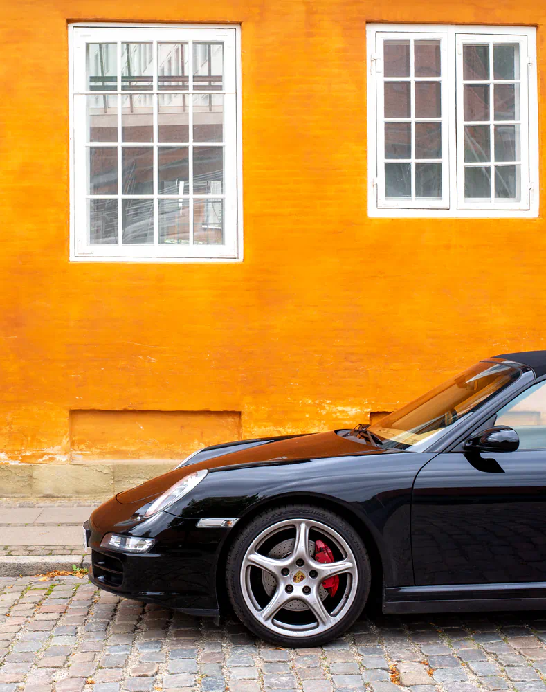 porsche in front of orange wall